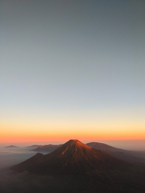 Scenic view of landscape against clear sky during sunset