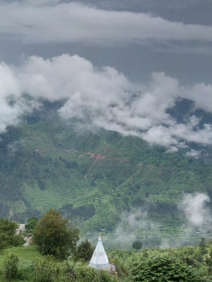 फोटो बादलों से भरे आकाश के सामने भूदृश्य का सुंदर नज़ारा