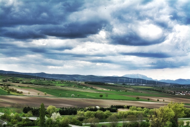 Scenic view of landscape against cloudy sky