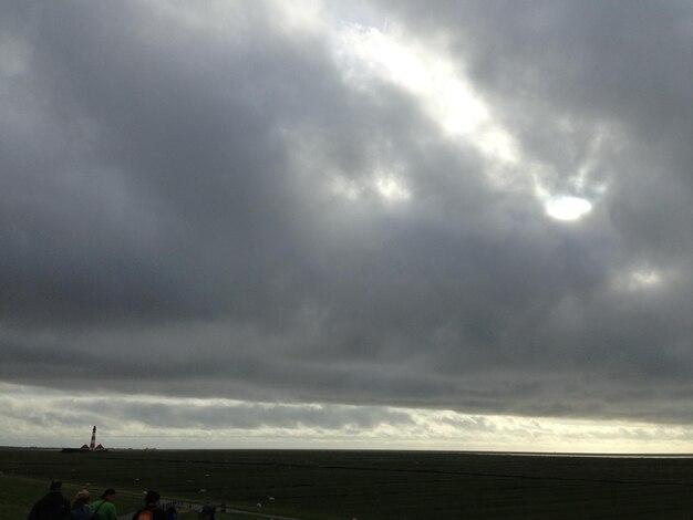 Scenic view of landscape against cloudy sky