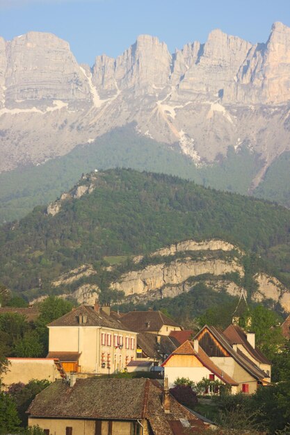 Photo scenic view of landscape and houses against mountains