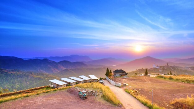 Scenic view of landscape and mountains against blue sky