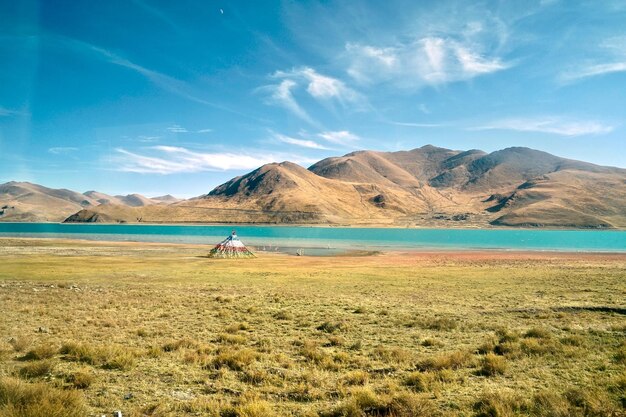 Scenic view of landscape and mountains against blue sky