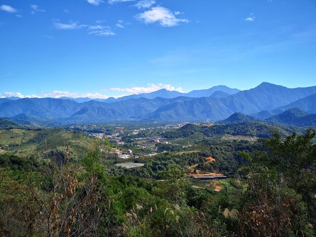 Scenic view of landscape and mountains against blue sky