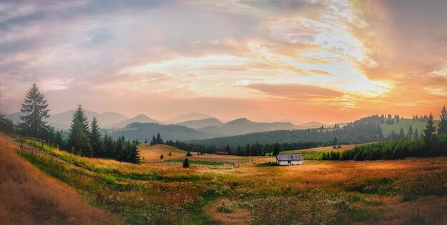scenic view of landscape and mountains against cloudy sky during sunset