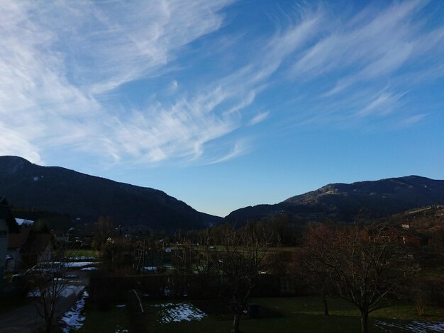 Scenic view of landscape and mountains against cloudy sky