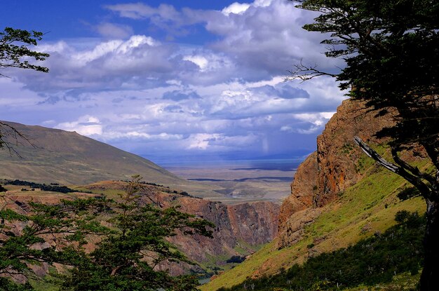 Scenic view of landscape and mountains against sky