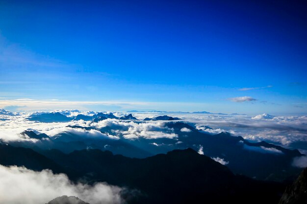 Scenic view of majestic mountains against blue sky