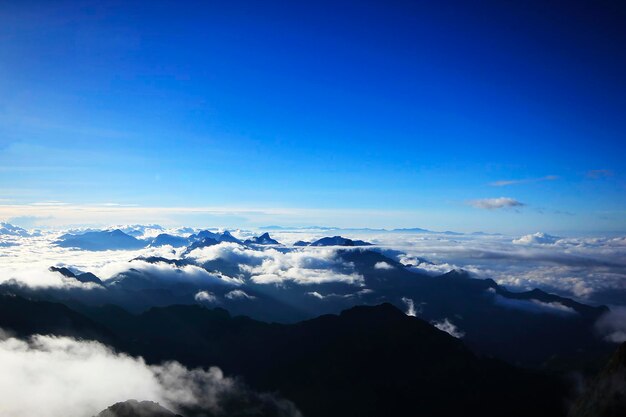 Scenic view of majestic mountains against blue sky