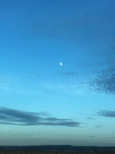 Scenic view of moon against blue sky