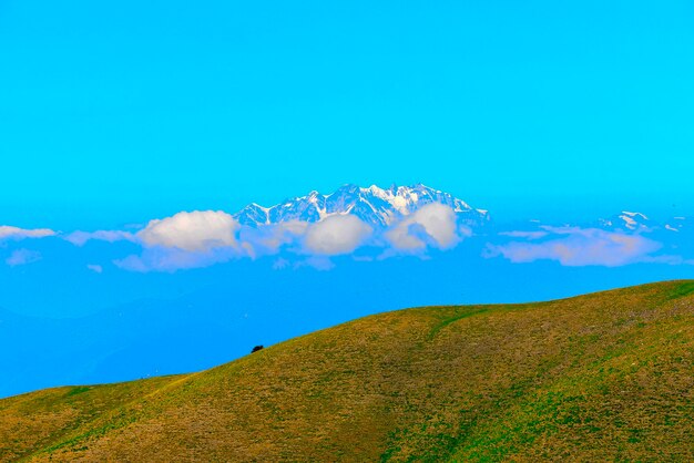 Scenic view of mountain against blue sky