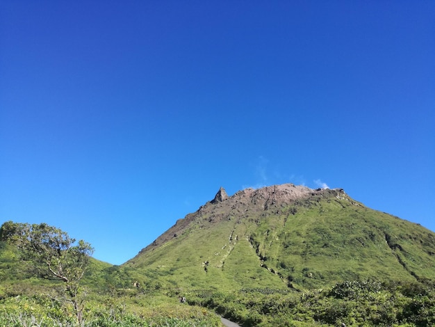 Scenic view of mountain against clear blue sky