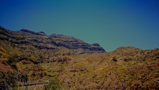 Scenic view of mountain against clear blue sky