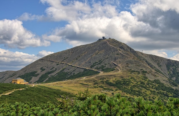 scenic view of mountain against cloudy sky