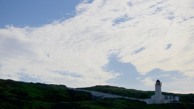 scenic view of mountain against cloudy sky