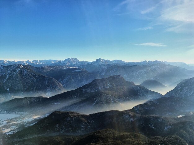 Scenic view of mountain range against blue sky