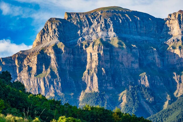 Scenic view of mountain range against cloudy sky