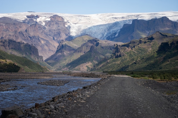 Scenic view Of Mountain Road Among Snowy Mountains nearby river in Thorsmork, Iceland.