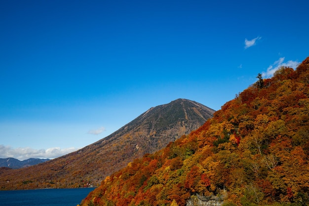 Scenic view of mountains against blue sky during autumn