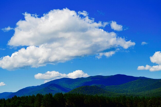 Scenic view of mountains against blue sky