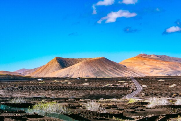 Scenic view of mountains against blue sky