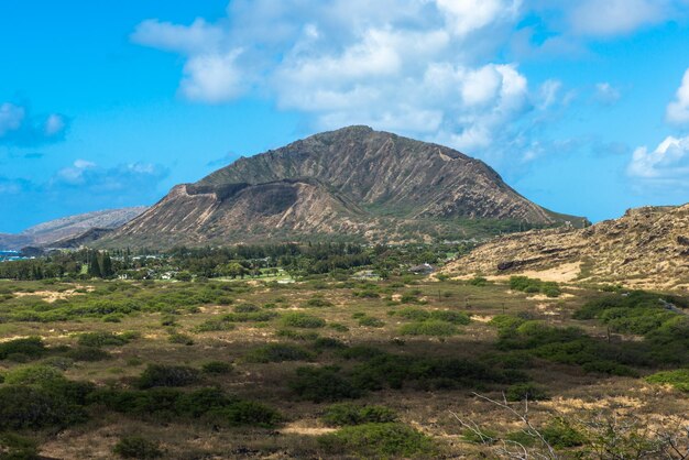 Scenic view of mountains against blue sky