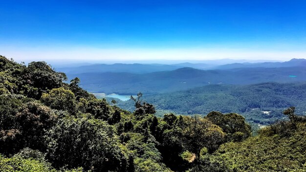 Scenic view of mountains against blue sky