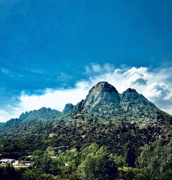 Scenic view of mountains against blue sky