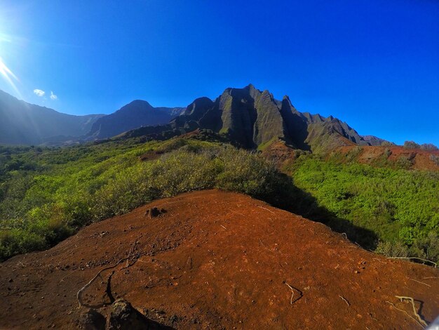 Scenic view of mountains against blue sky