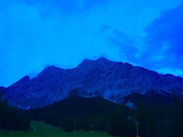 Scenic view of mountains against blue sky