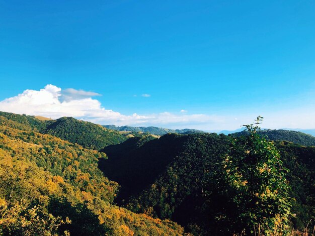 Scenic view of mountains against blue sky