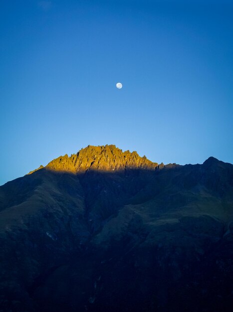 Scenic view of mountains against blue sky