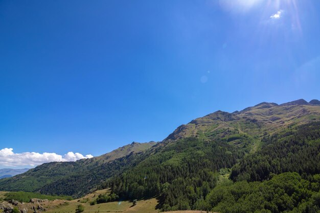 Scenic view of mountains against blue sky