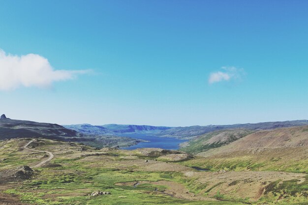 Scenic view of mountains against blue sky