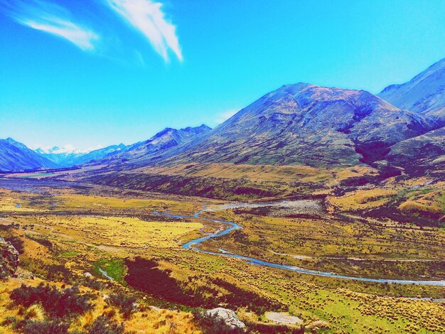 Scenic view of mountains against blue sky