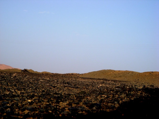 Scenic view of mountains against blue sky