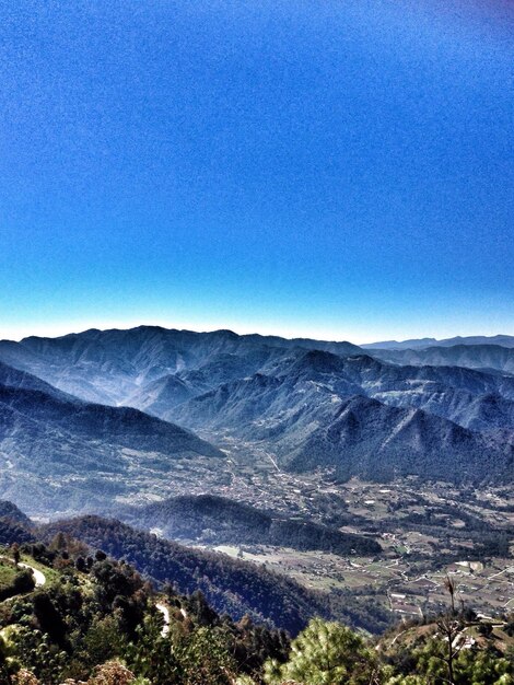 Scenic view of mountains against blue sky