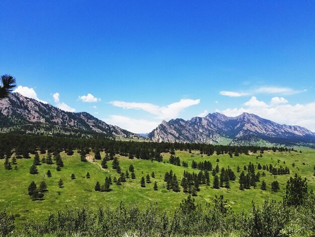 Scenic view of mountains against blue sky