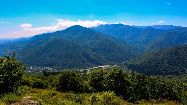 Scenic view of mountains against blue sky