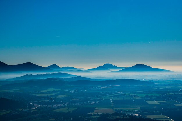 Scenic view of mountains against clear blue sky