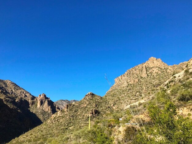 Scenic view of mountains against clear blue sky