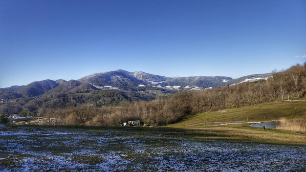 Scenic view of mountains against clear blue sky