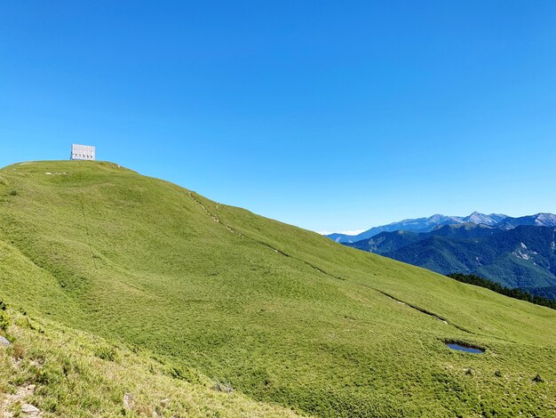 Scenic view of mountains against clear blue sky