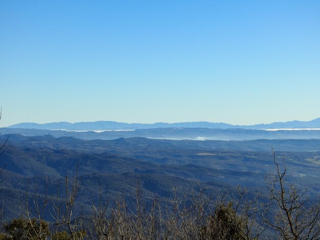 Scenic view of mountains against clear blue sky