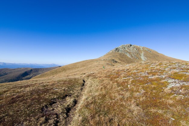 Scenic view of mountains against clear blue sky