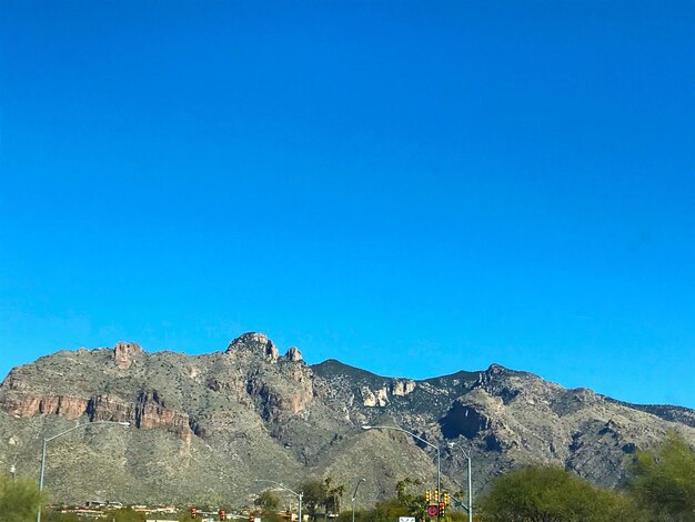 Scenic view of mountains against clear blue sky