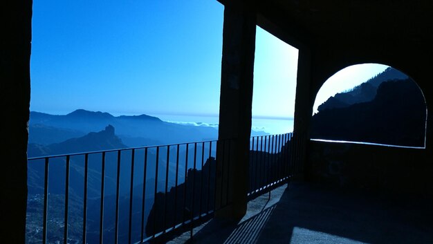 Scenic view of mountains against clear blue sky