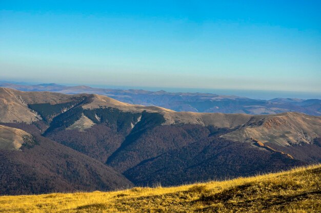 Scenic view of mountains against clear blue sky