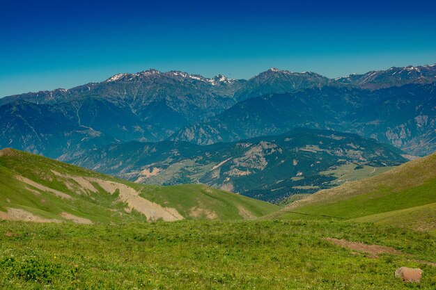 Scenic view of mountains against clear blue sky