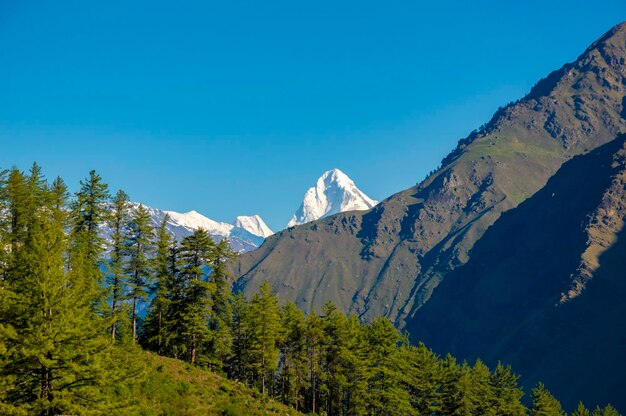 Scenic view of mountains against clear blue sky